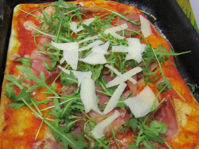 Pizza with organic Italian speck and rucola